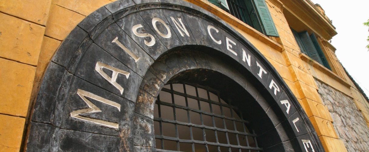 Stone Maison Centrale lettering above the arched entrance of Hoa Lo Prison in Hanoi