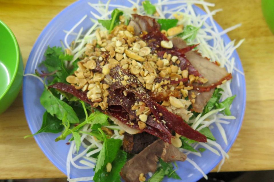 Plate of dried beef salad with green papaya, herbs and crushed peanuts