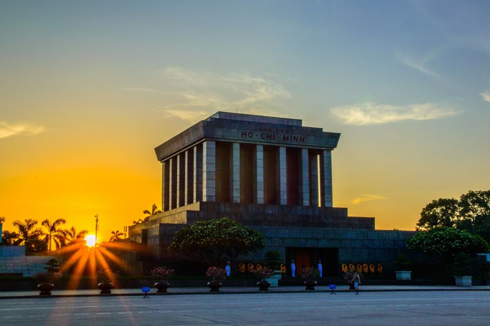Ho Chi Minh Mausoleum at sunrise with the sun low behind the granite building