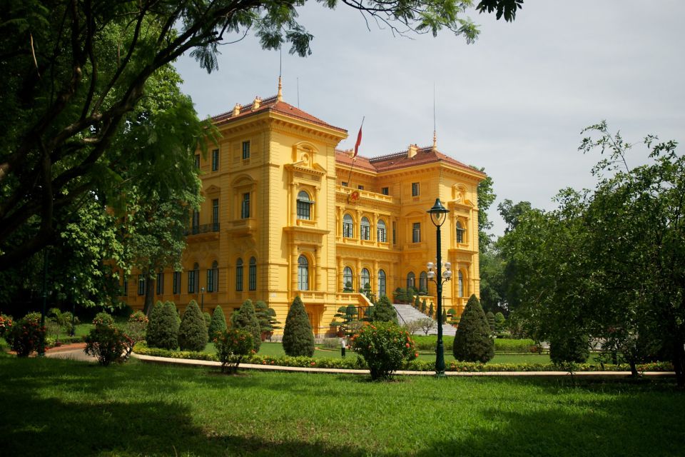 Yellow Presidential Palace seen across its lawn in the Ho Chi Minh Complex